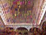 Rows of artisanal piñatas hanging against a backdrop of festive papel picado banners.