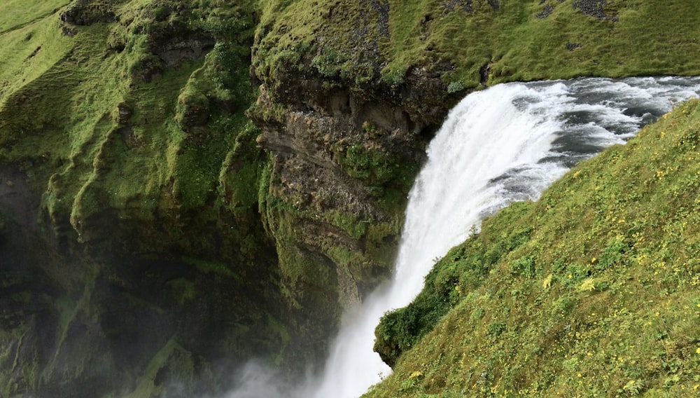 a large waterfall with water cascading down the side of it