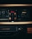 An old-school audio tape deck and VHS player setup is centered in this image. A cassette tape featuring an album cover with four faces and the text 'Bone' and 'Crossroads' is prominently placed in front of the tape deck.