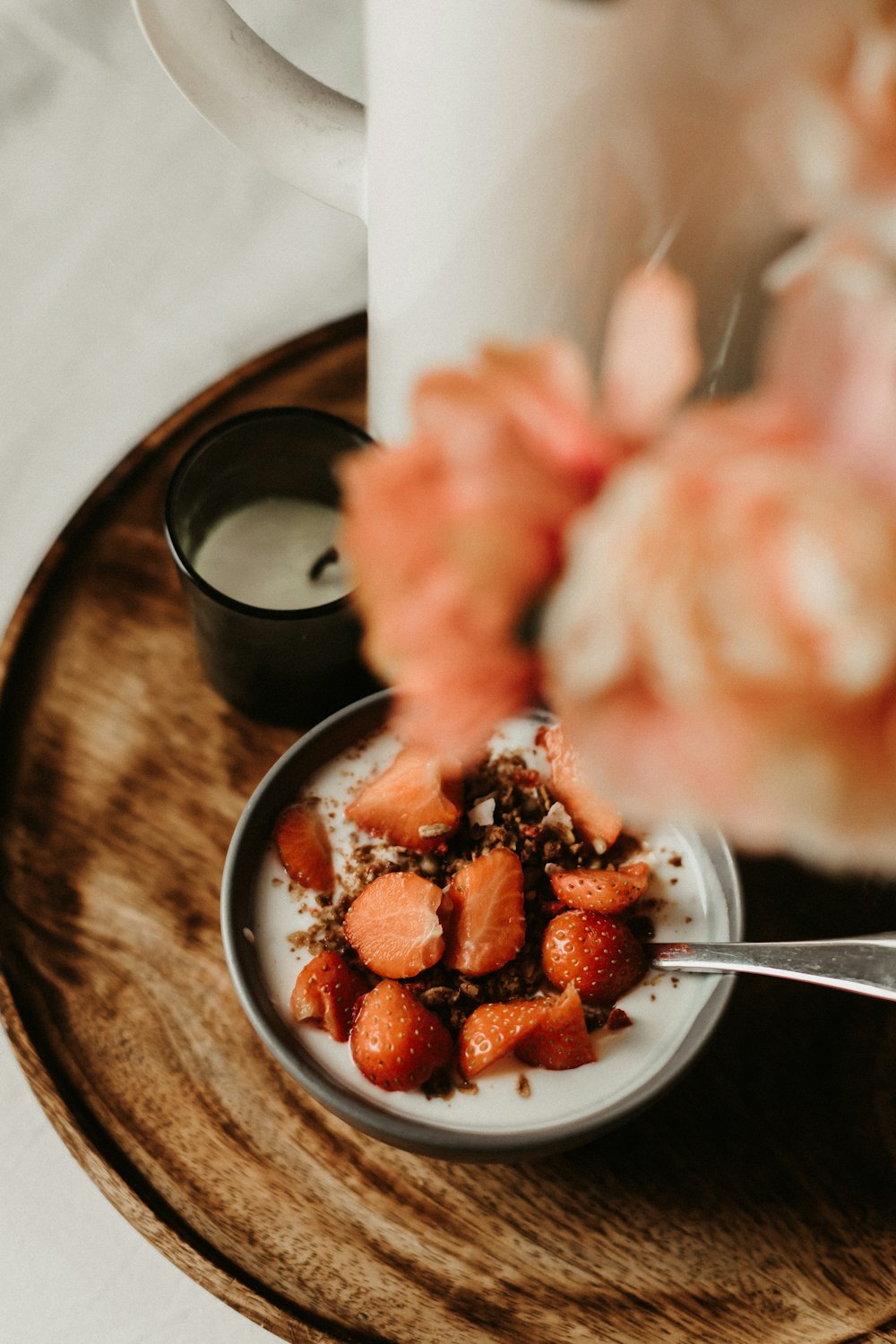 a small bowl of food on a wooden plate