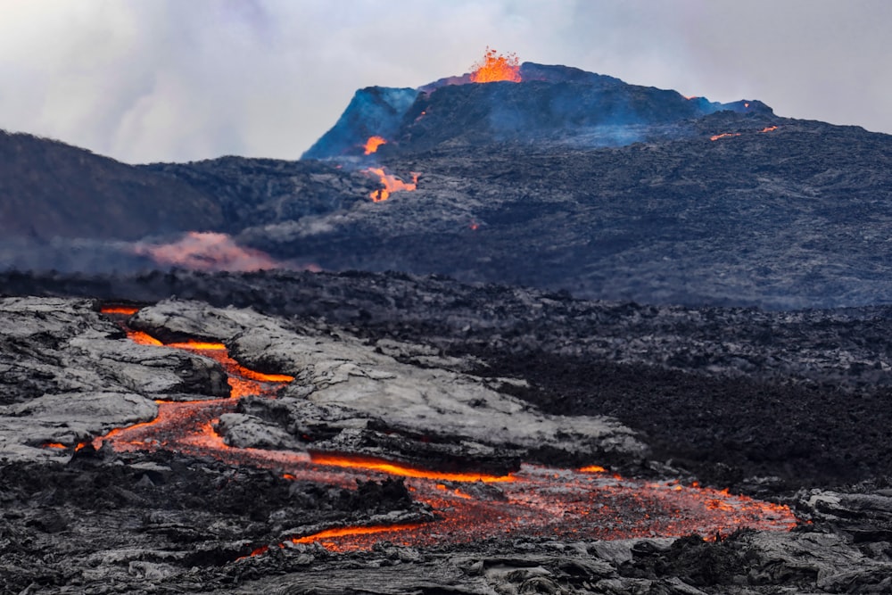 a mountain with lava flowing down the side of it