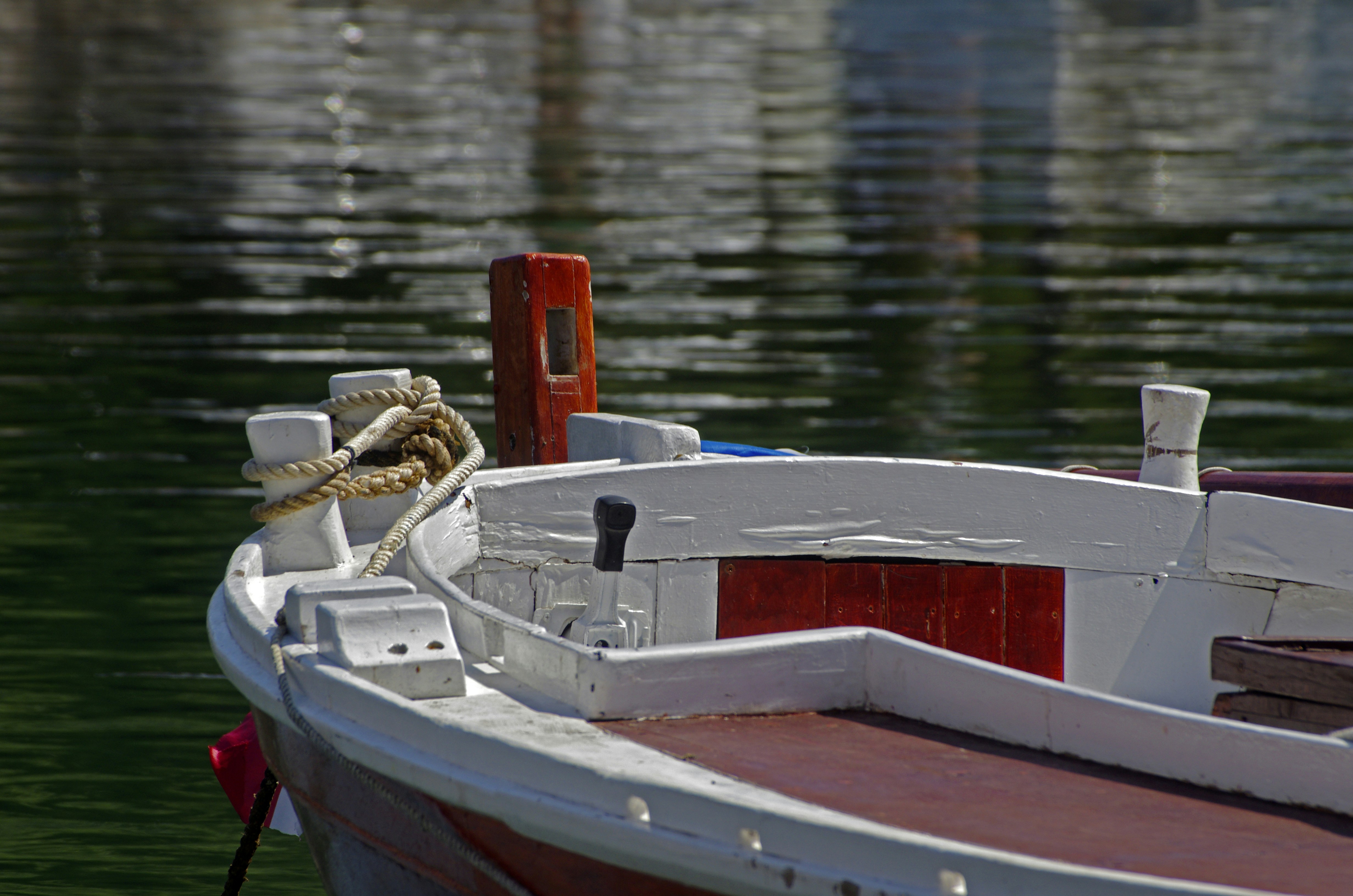 A white and red boat in a body of water