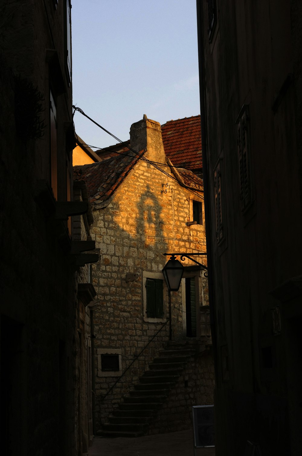 a stone building with a clock on the side of it