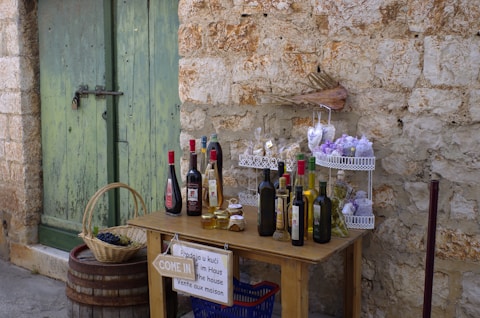 a wooden table topped with bottles of wine