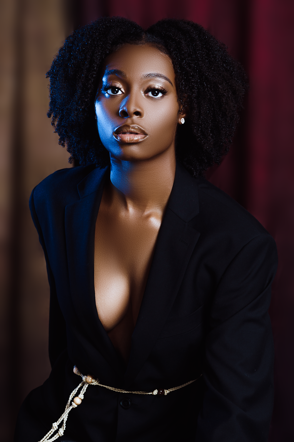 a woman in a black suit posing for a picture