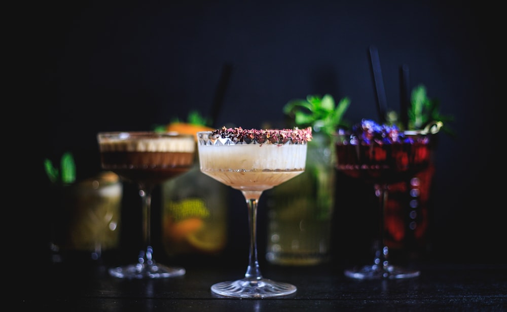 a close up of three cocktails on a table