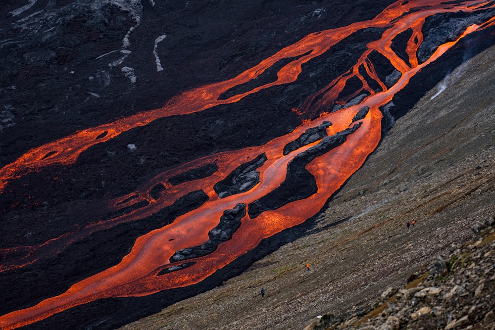 an orange stream of water flowing down a mountain side