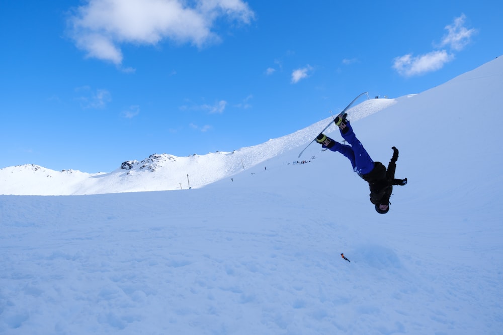 a man flying through the air while riding skis