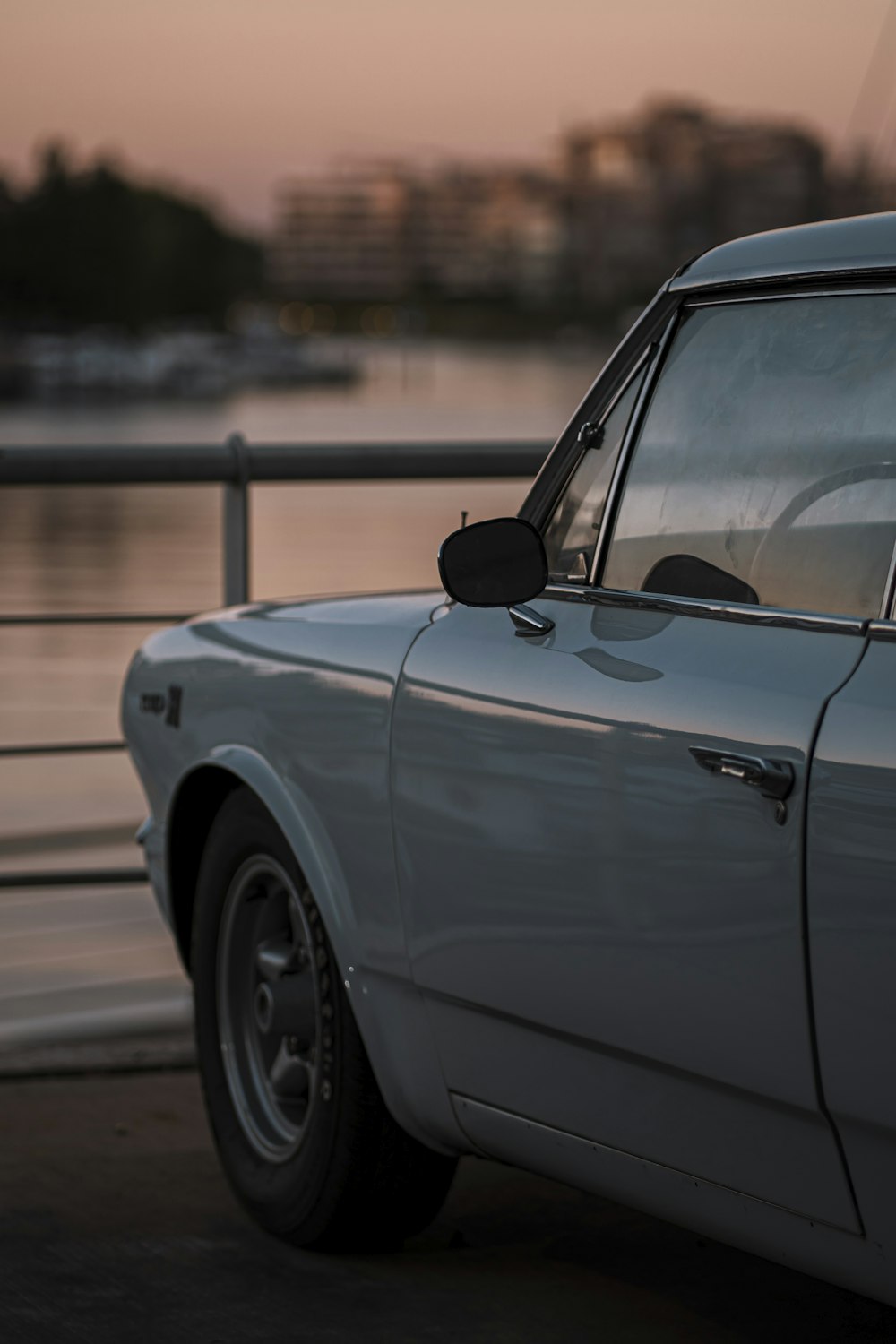 a car parked next to a body of water