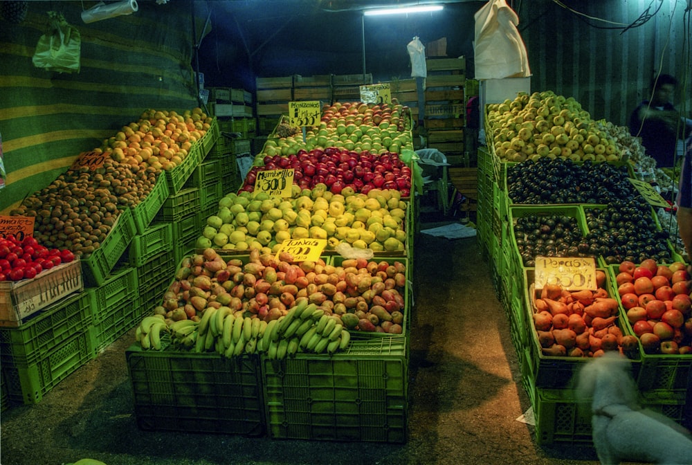 a bunch of crates filled with lots of fruit