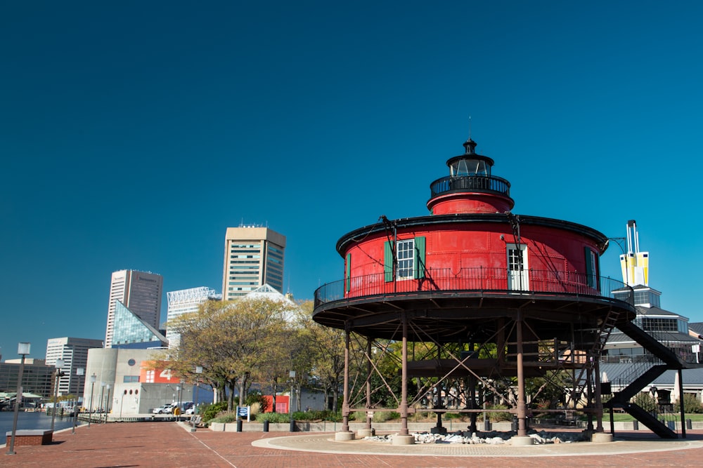 a large red tower with a clock on top of it