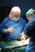 two surgeons performing surgery on a patient