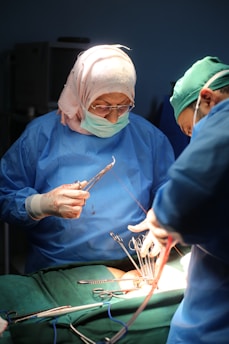 two surgeons performing surgery on a patient