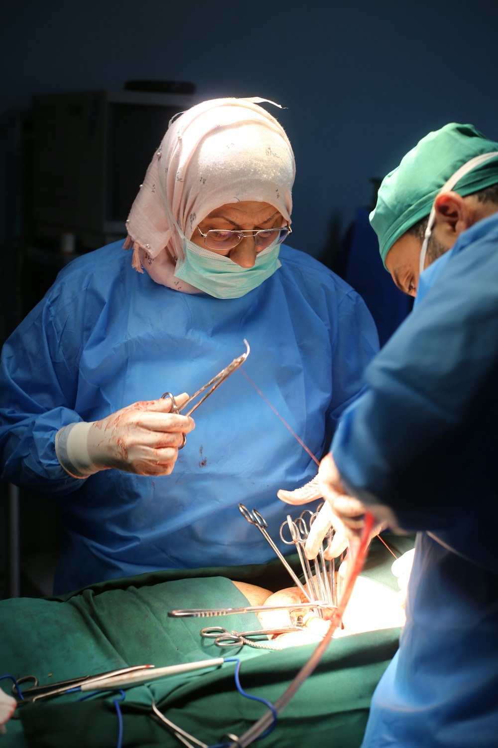 two surgeons performing surgery on a patient