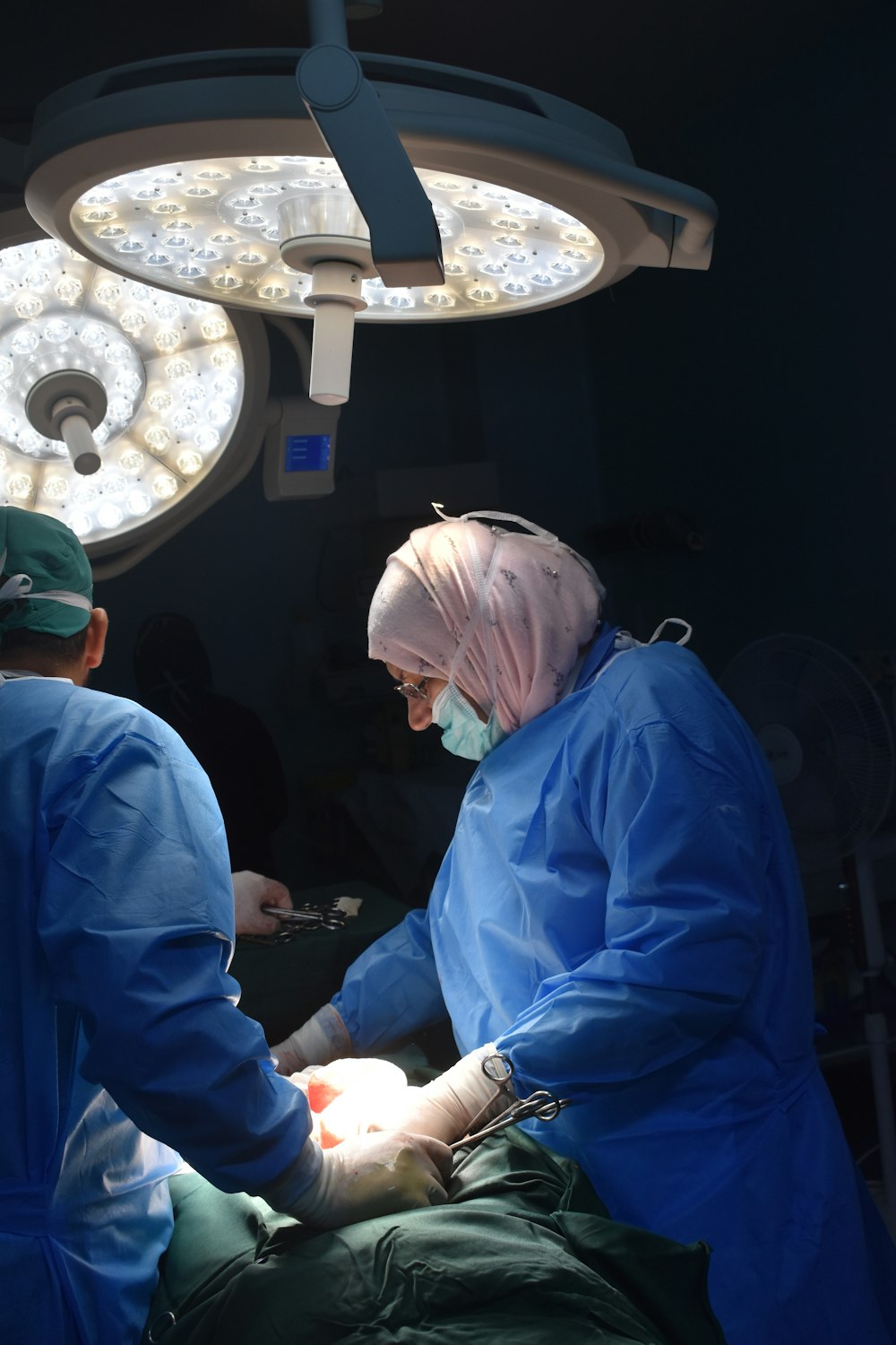 a group of doctors performing surgery on a patient