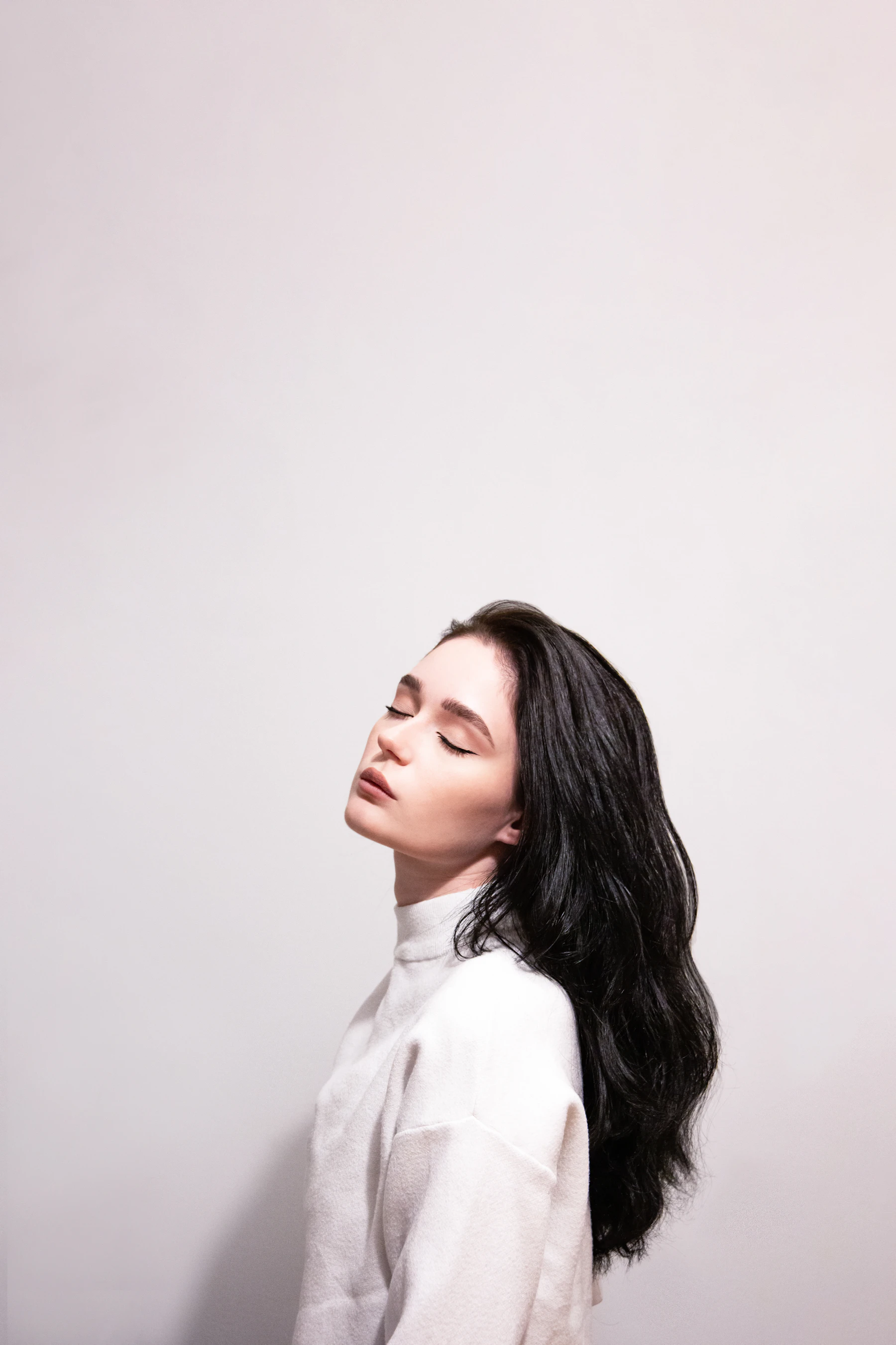 Portrait of a woman with long dark hair, soft warm lighting