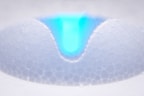 a close up of a white object with a blue center