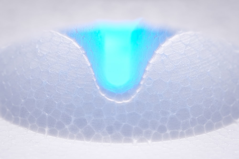 a close up of a white object with a blue center