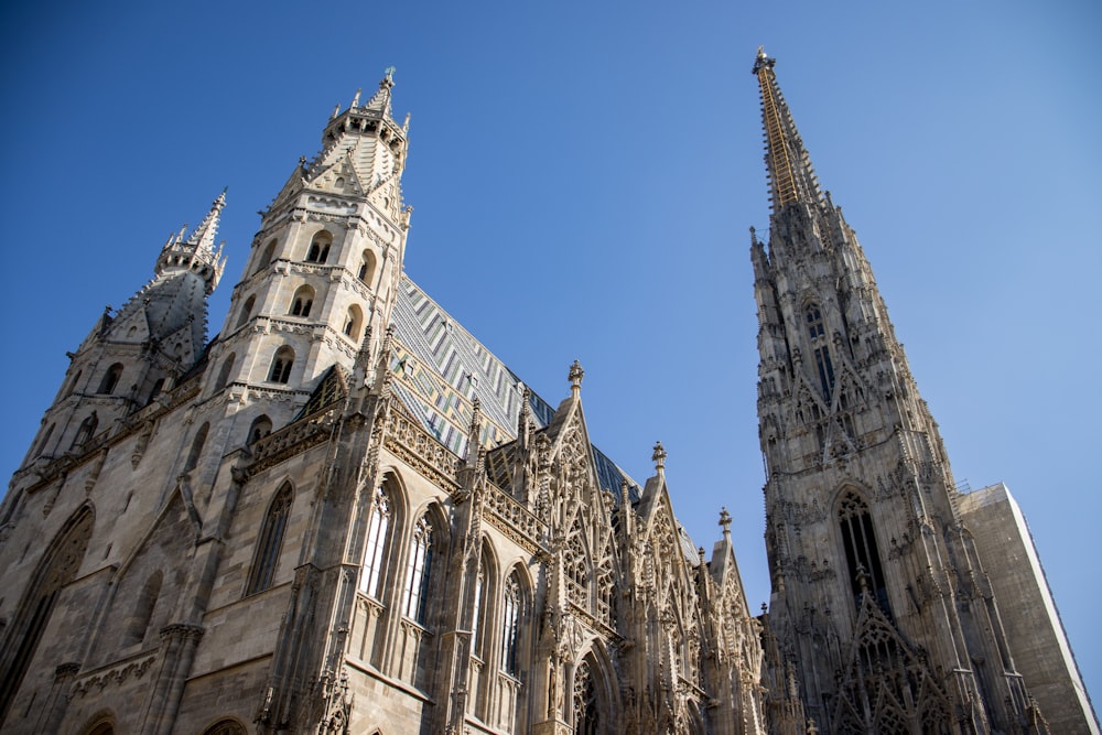 a tall cathedral with a clock on it's side