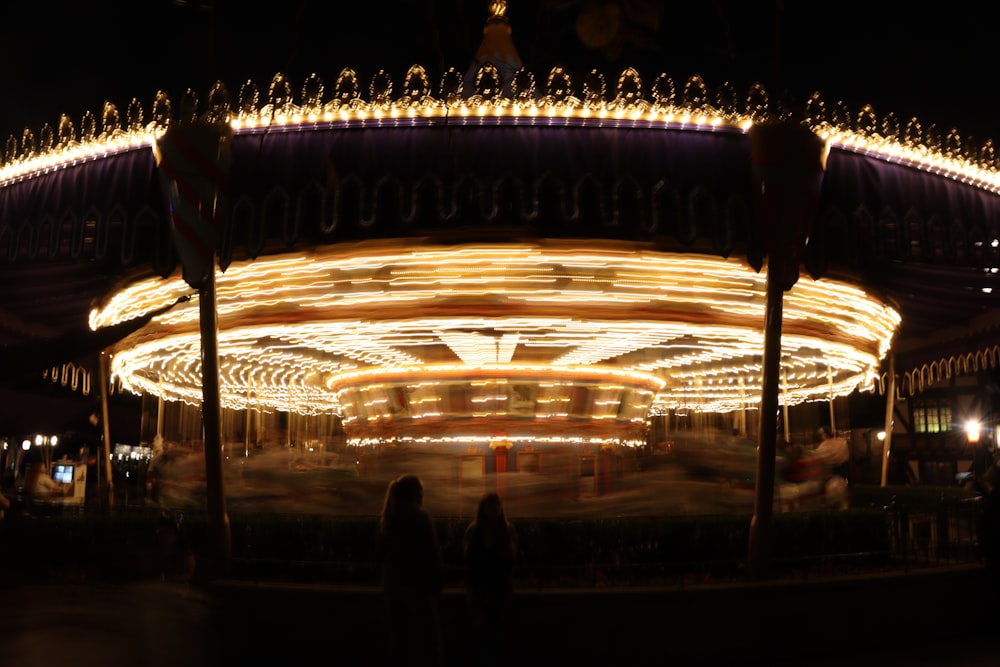 a blurry photo of a merry go round at night