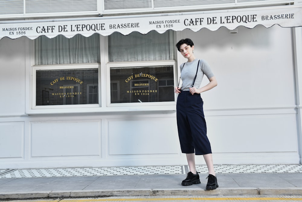 a woman standing in front of a cafe