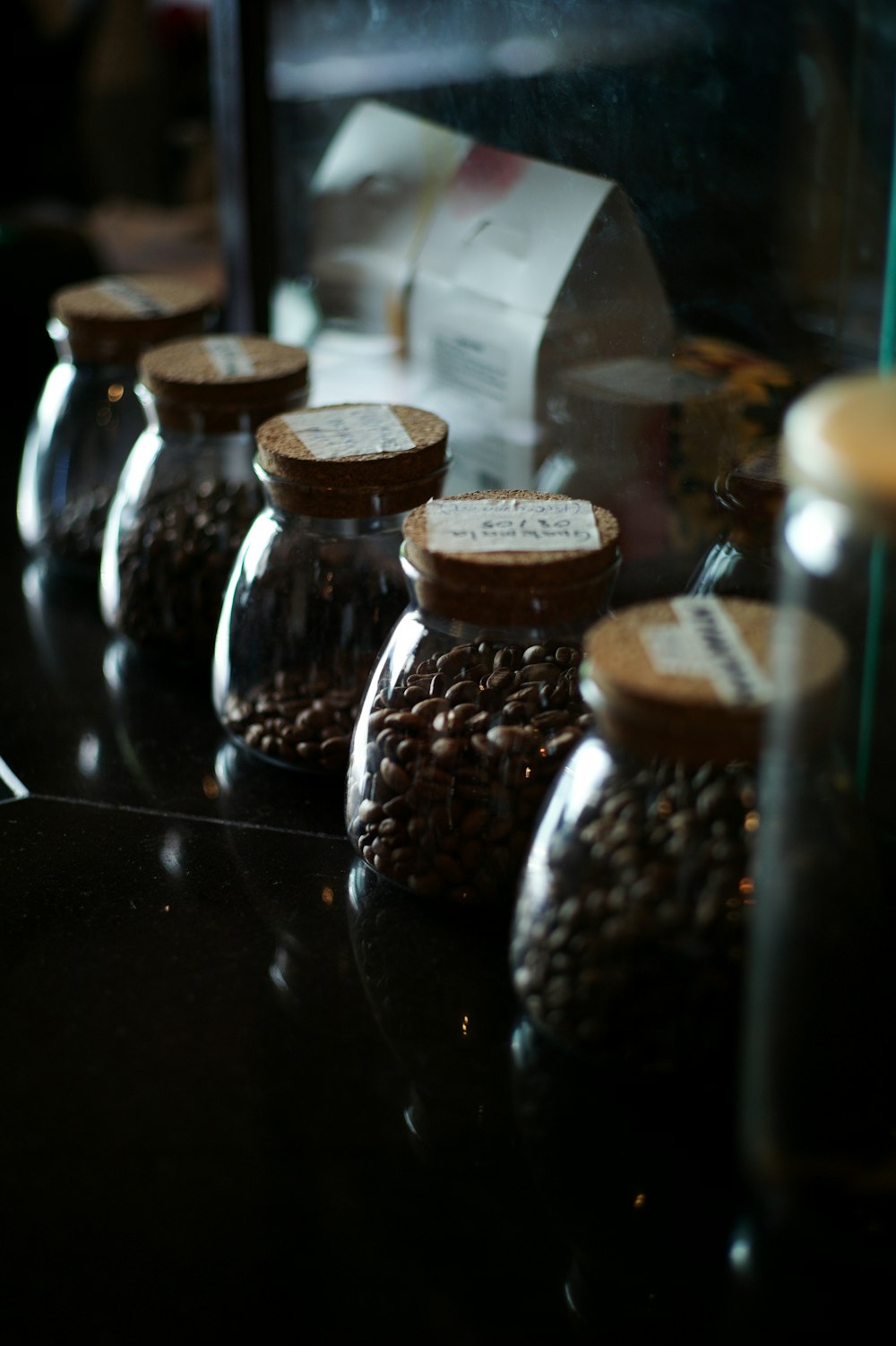 a row of glass jars filled with nuts