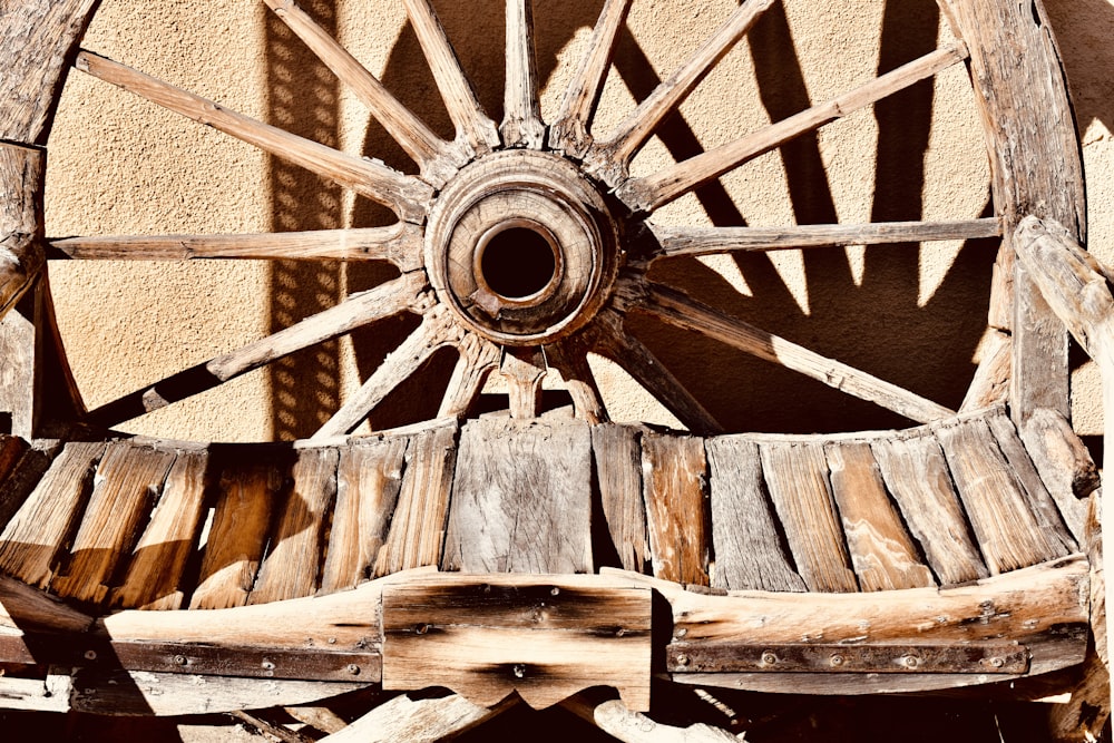 an old wooden wagon wheel on display outside
