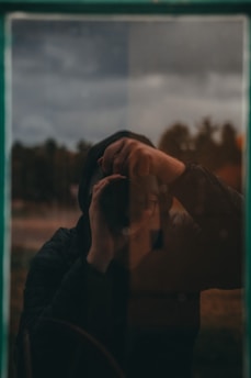 a person holding a cell phone up to their face