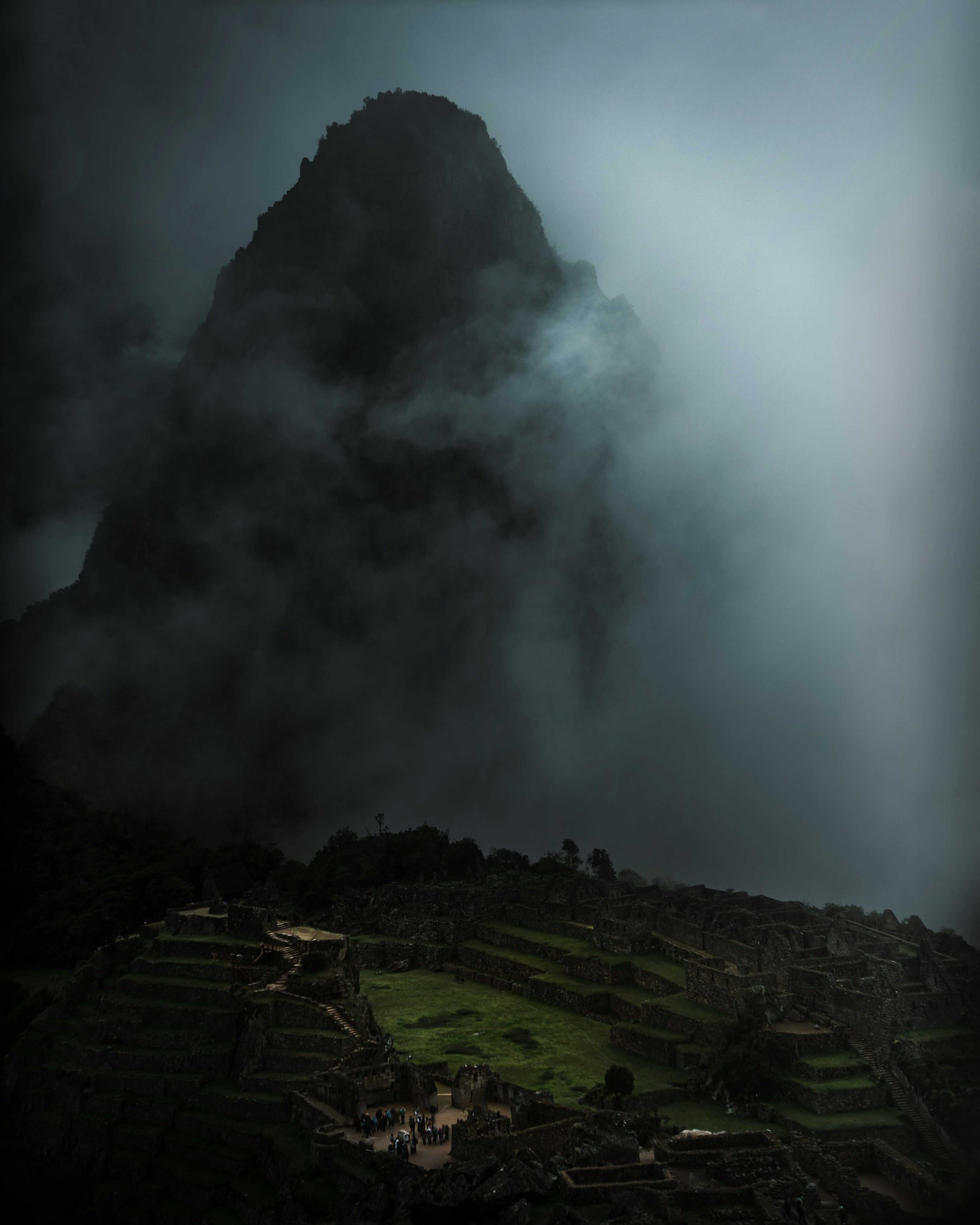 a large mountain with a very dark sky above it