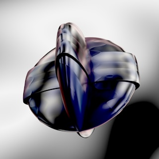 A helix sculpture viewed from above, its shadows softly fading into a deep-charcoal matte backdrop.