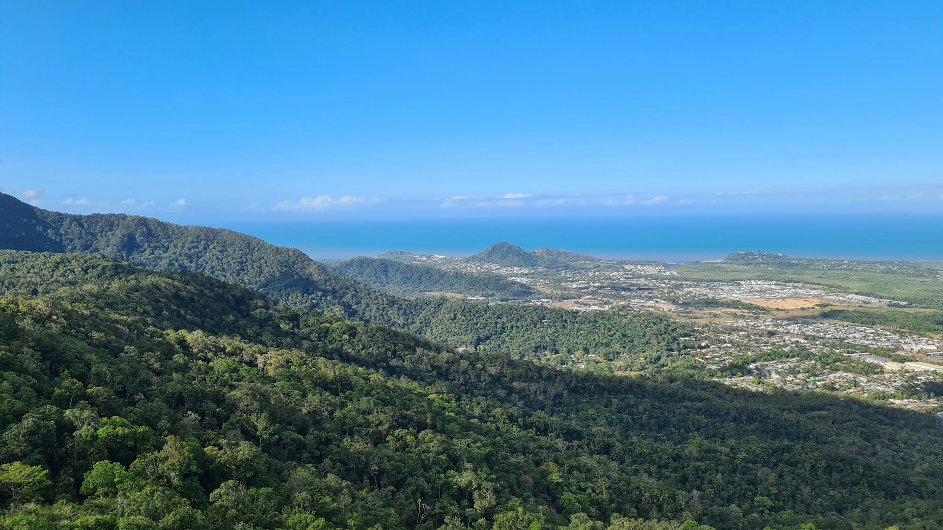 a scenic view of a city and a body of water