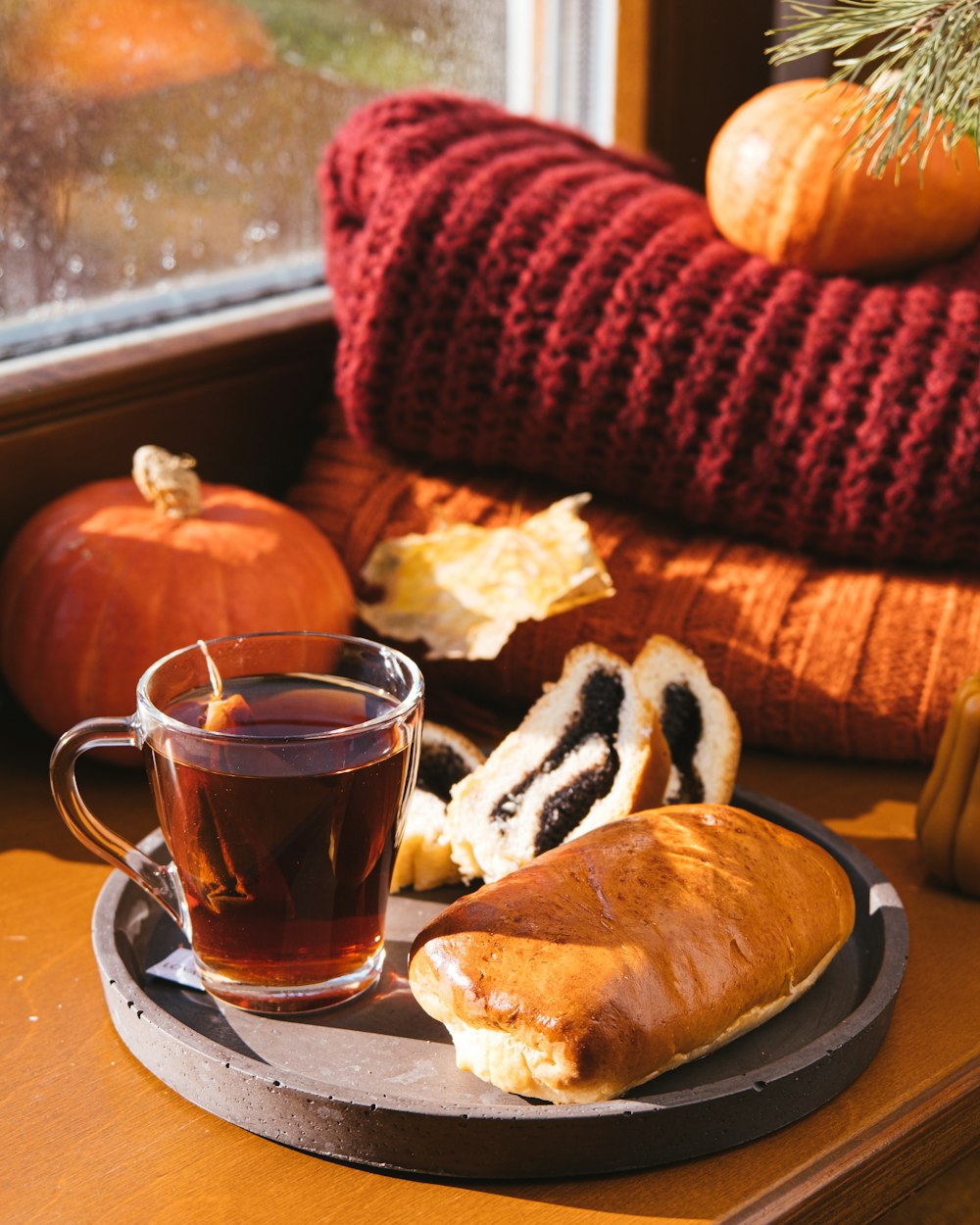 a cup of tea and a piece of bread on a plate