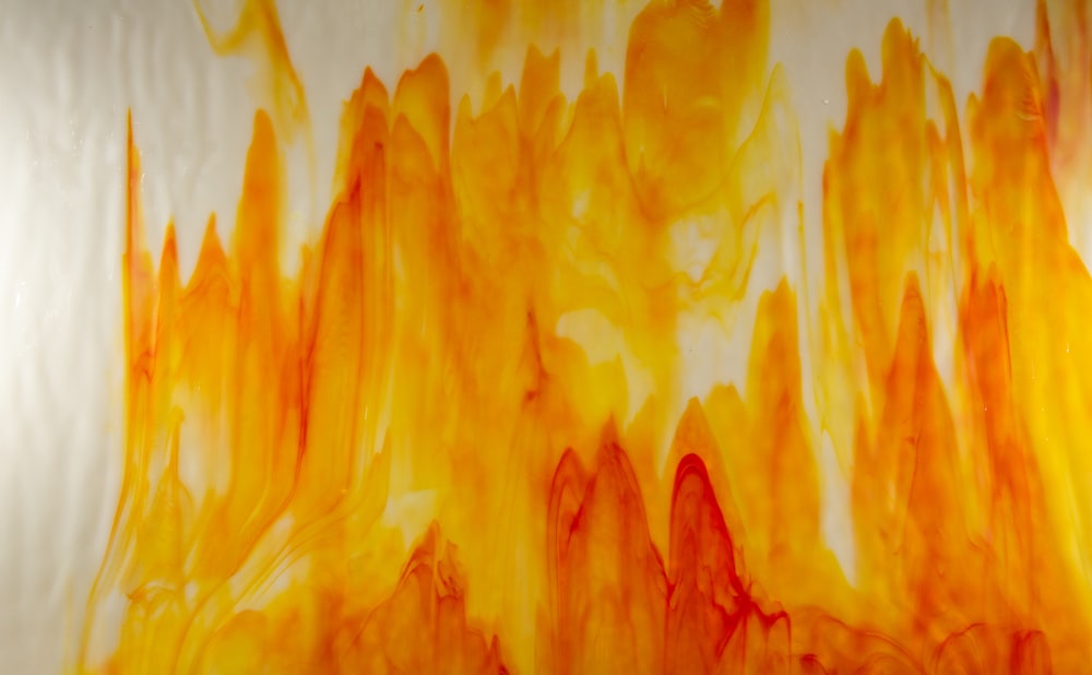 a painting of orange and yellow colors on a white background