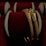 Two intricately designed gold bangles are displayed against a luxurious red velvet background, highlighting the jewelry's elegance and craftsmanship.