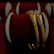 Two intricately designed gold bangles are displayed against a luxurious red velvet background, highlighting the jewelry's elegance and craftsmanship.