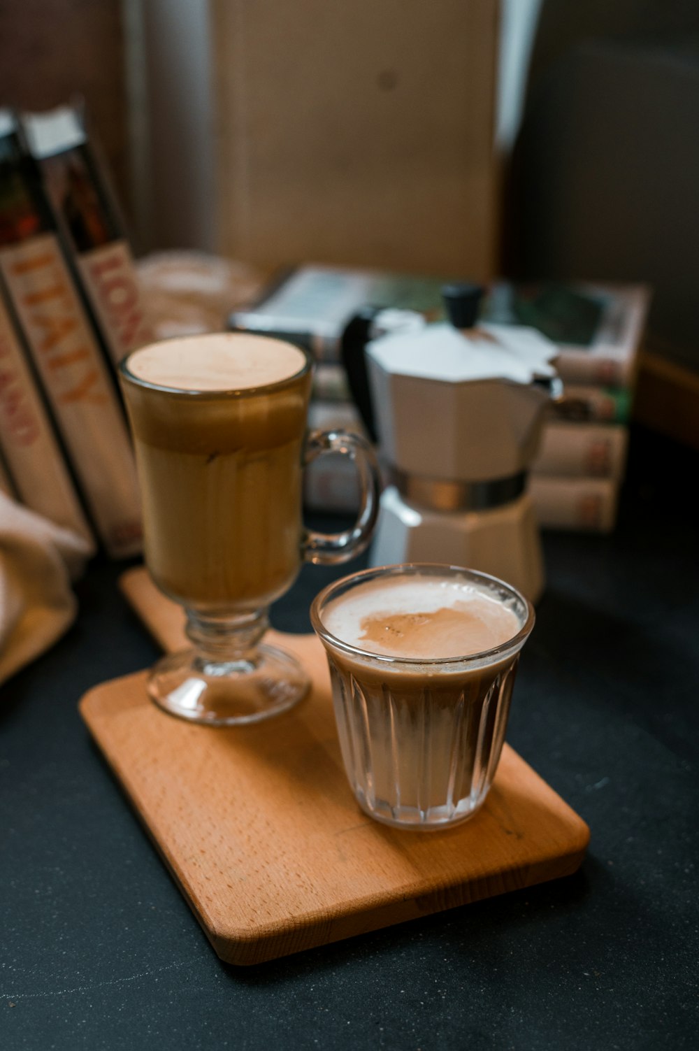 a cup of coffee sitting on top of a wooden tray