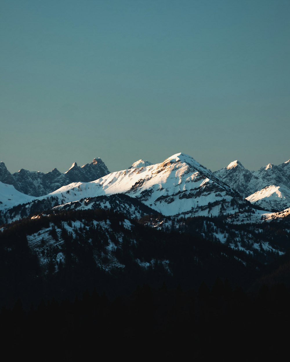 a view of a mountain range with snow on it