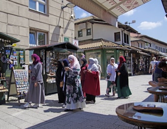 a group of people standing outside of a store