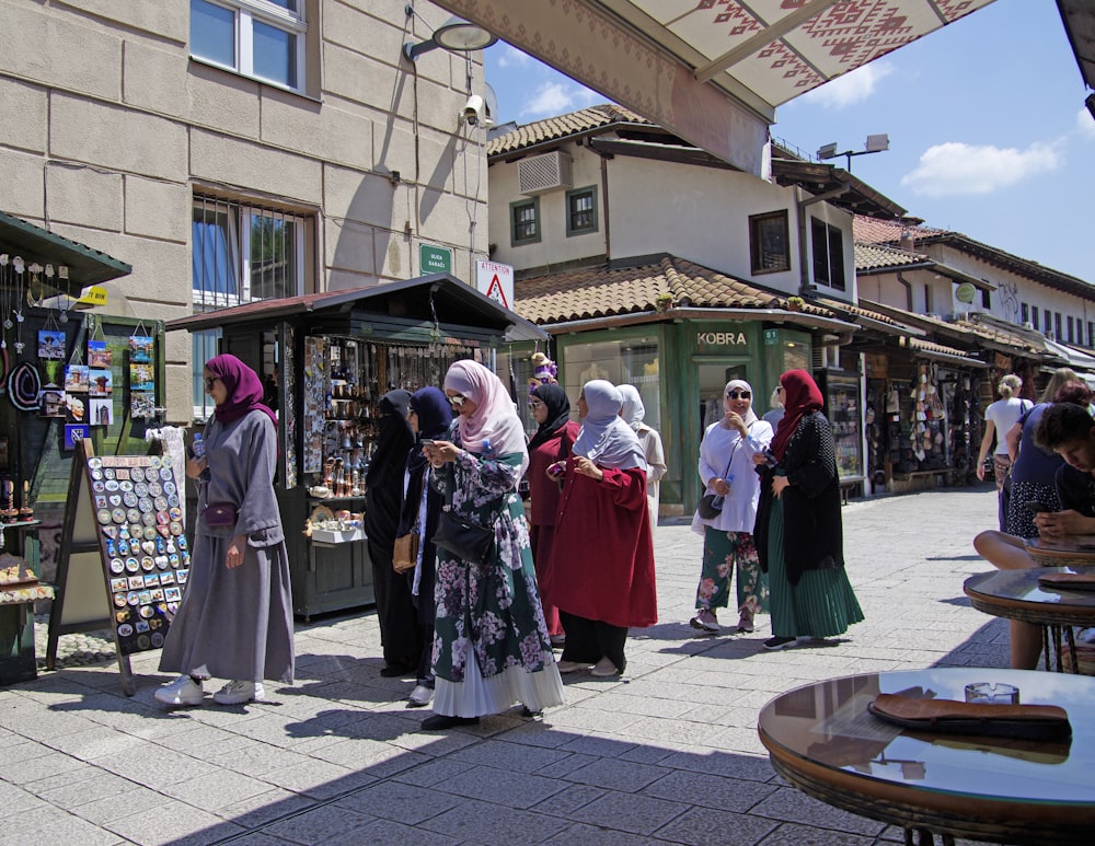 a group of people standing outside of a store