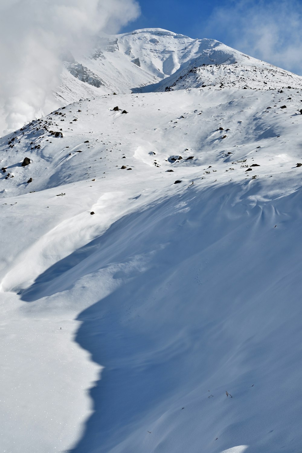 a man riding skis down a snow covered slope