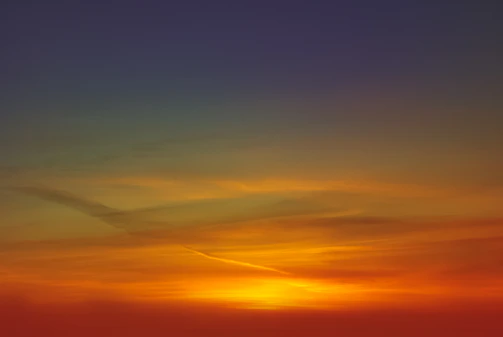 A vibrant weather map showing temperature gradients across a country at sunset.