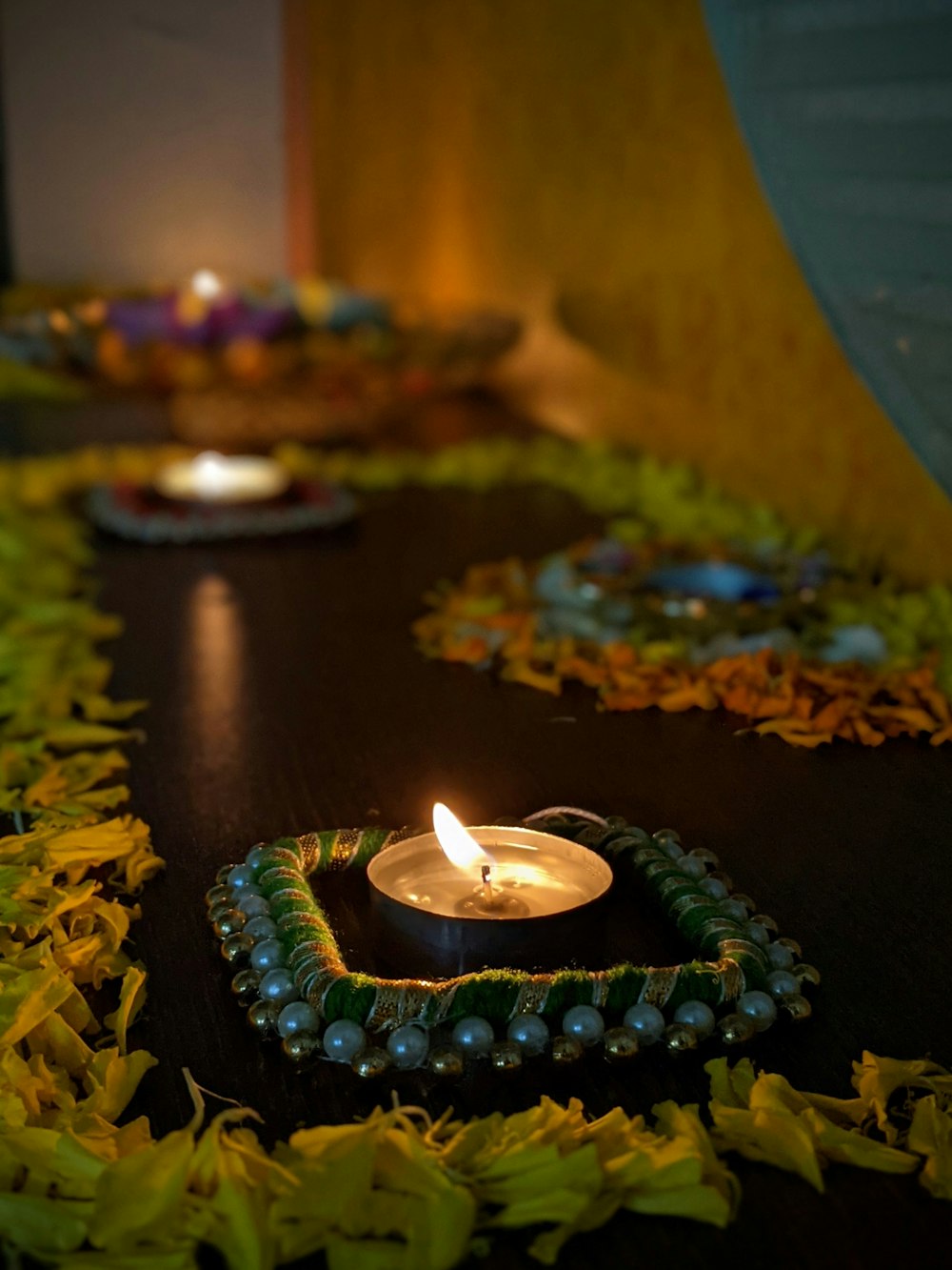 a lit candle sitting on top of a wooden table