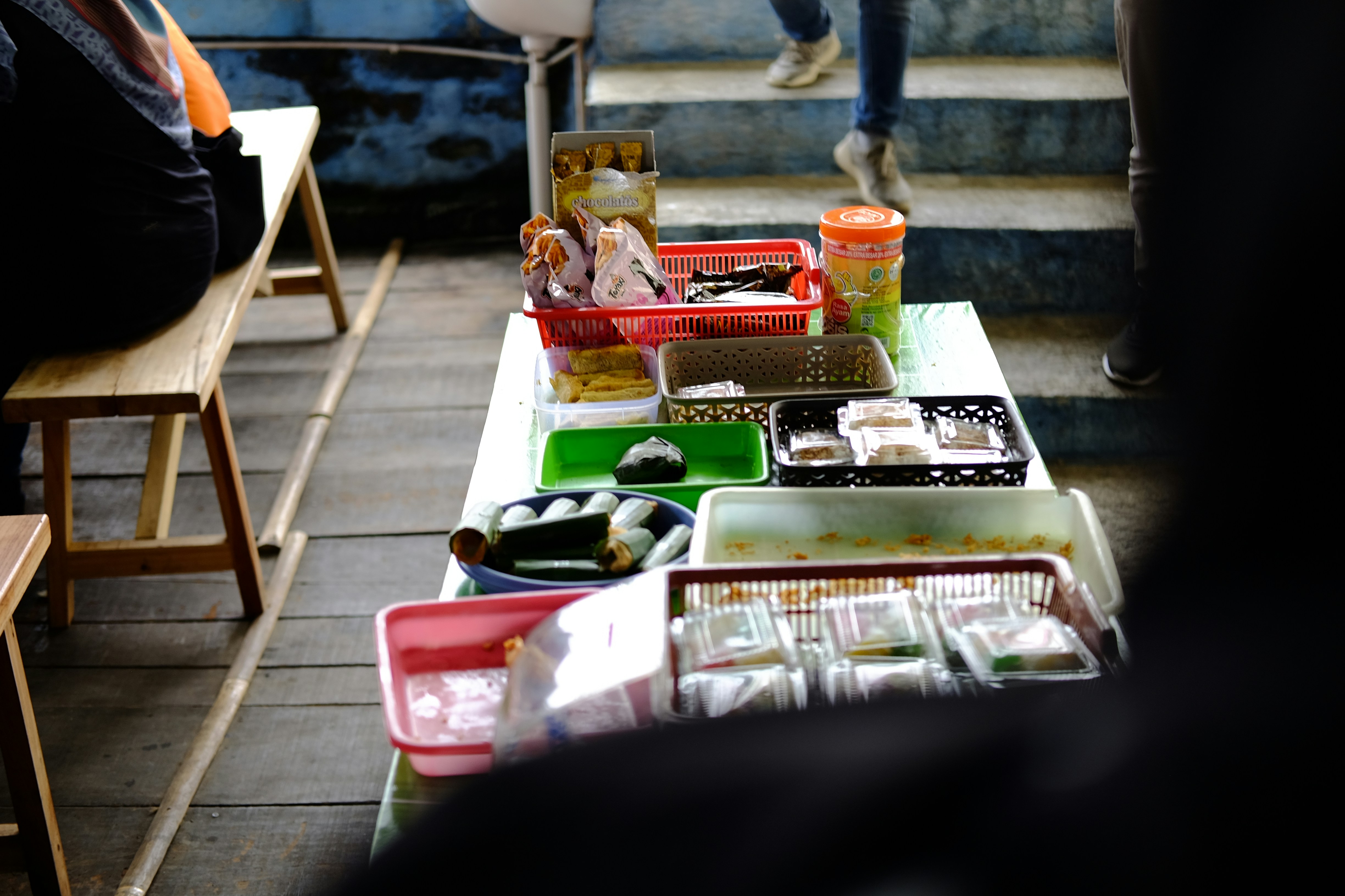 Assorted packaged biscuits and snacks neatly arranged, bright neutral background