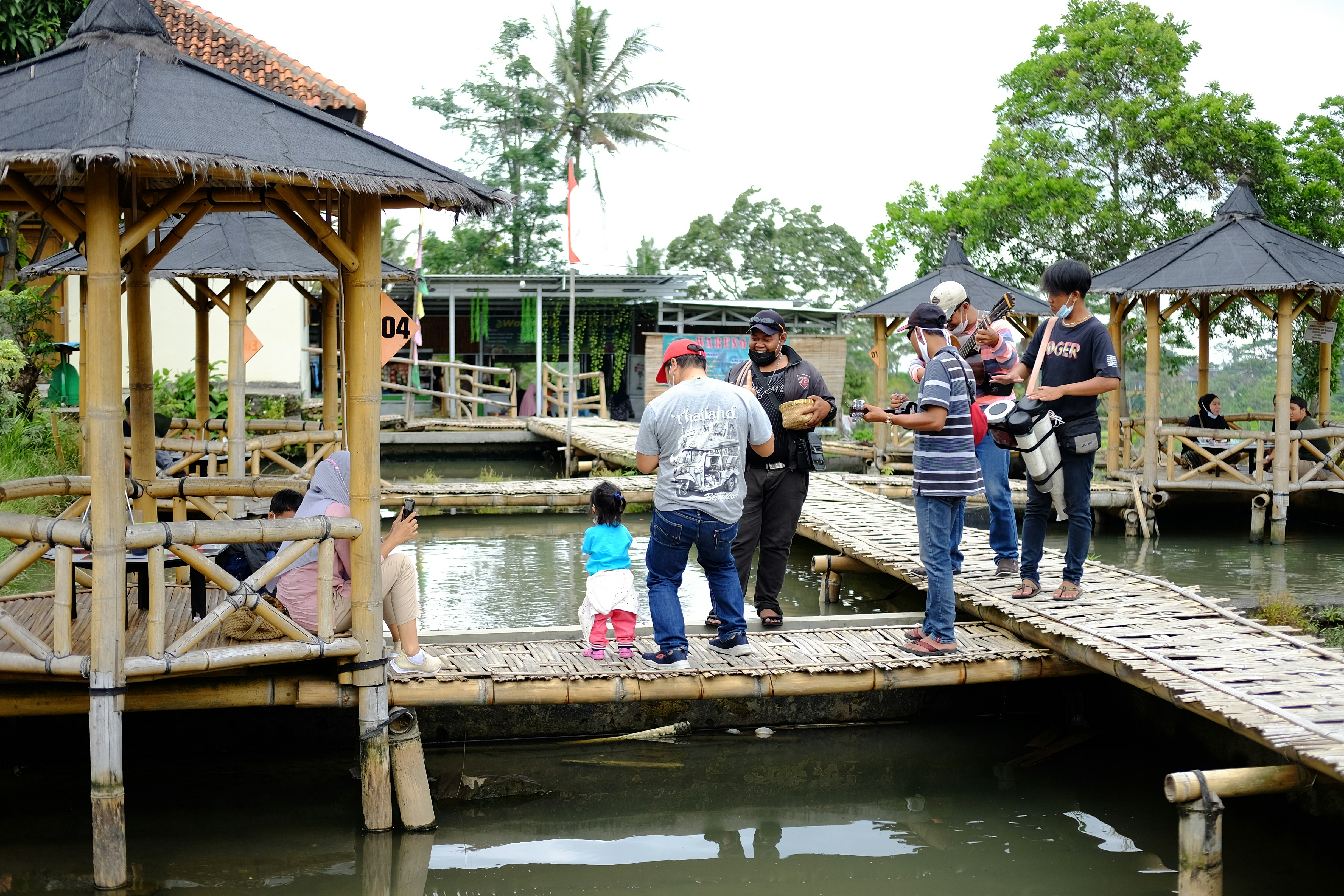 um grupo de pessoas em pé em uma ponte de madeira