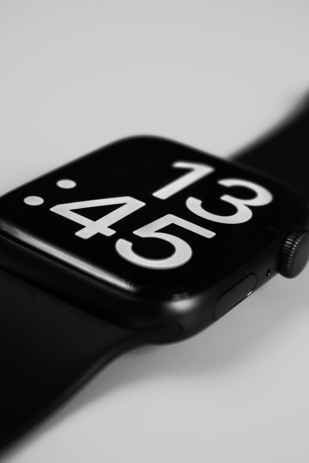 a close up of a black apple watch with white numbers