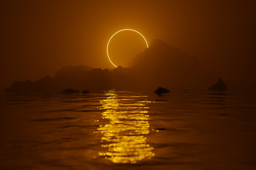 the sun is setting over a body of water,