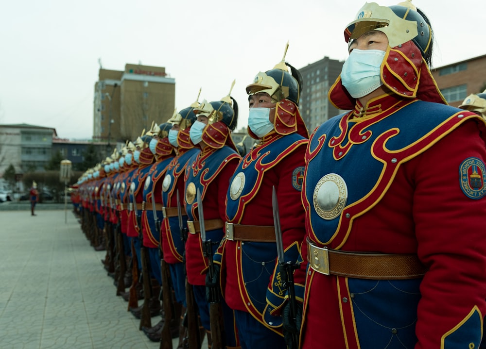 a row of men in red and blue uniforms