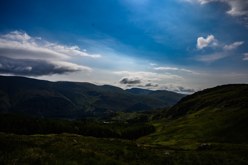 a view of a valley with mountains in the background