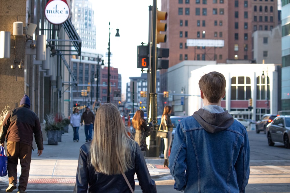 a man and a woman are walking down the street