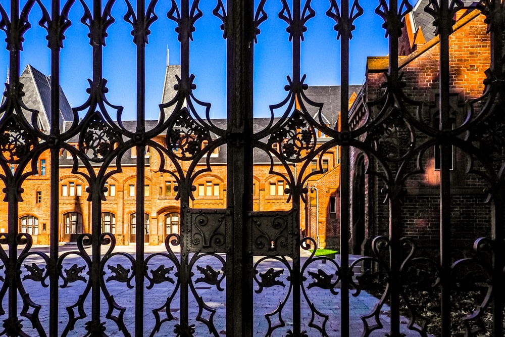 a gate with a building in the background